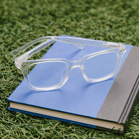 flat lay of clear blue light glasses on a book