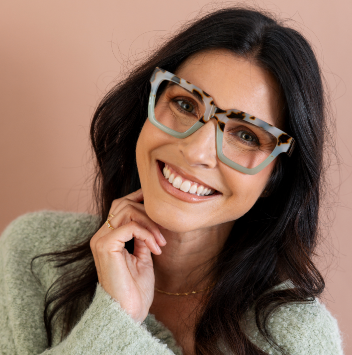 Women wearing green oversized reading glasses 