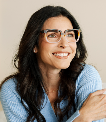 Women wearing brown and pink reading glasses smiling 