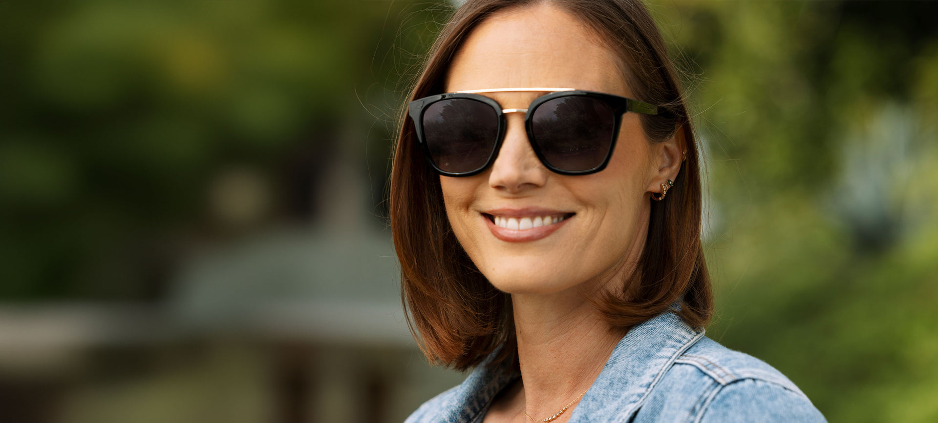 Main hero: Women wearing black polarized sunglasses outside