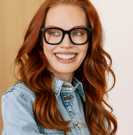 Women wearing black reading glasses smiling 