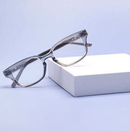 Gray reading glasses on a blue background