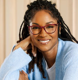 Women wearing pink reading glasses smiling