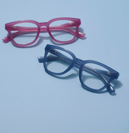 Pink and blue reading glasses on a blue background