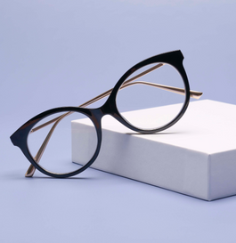 Round black and metal reading glasses on a blue background