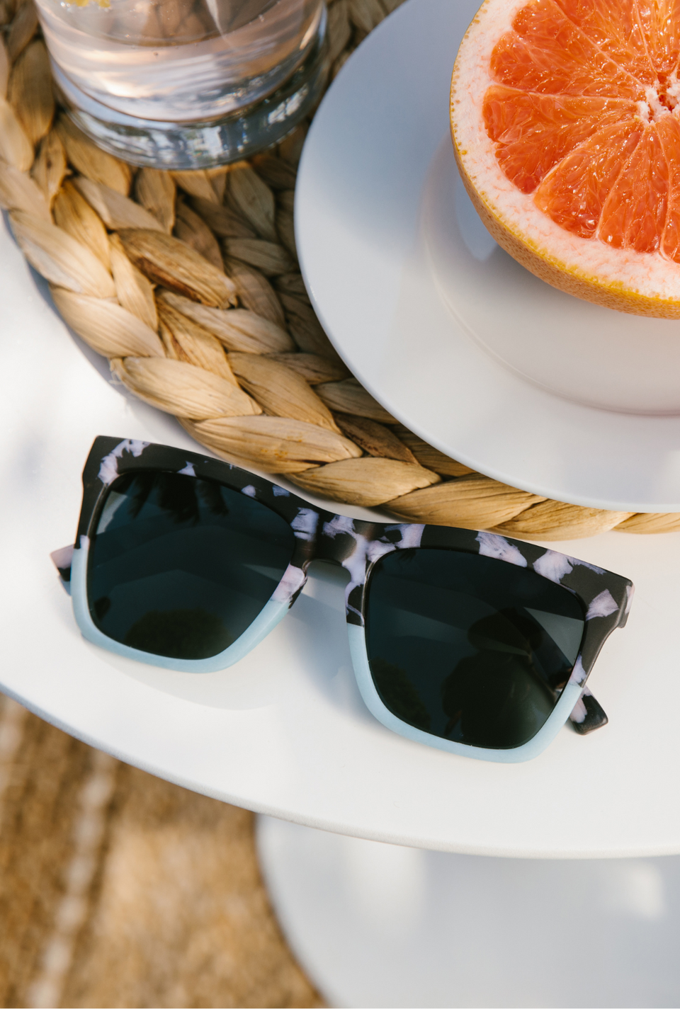 Teal sunglasses sitting on a table