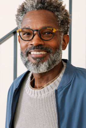 Man wearing black and tokyo tortoise reading glasses