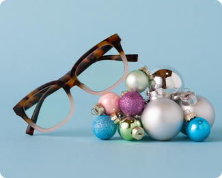 Decorative photo of glasses resting on Christmas ornaments