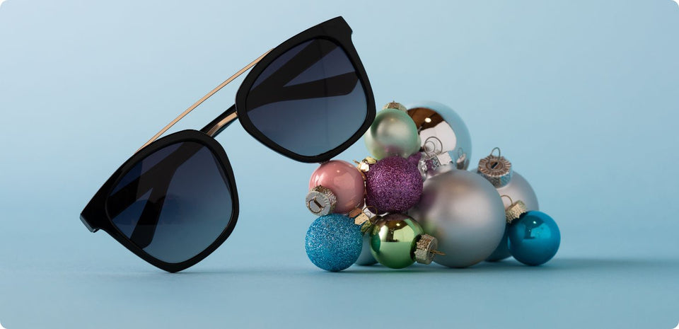 Black polarized sunglasses with a blue background and colorful ornaments below it