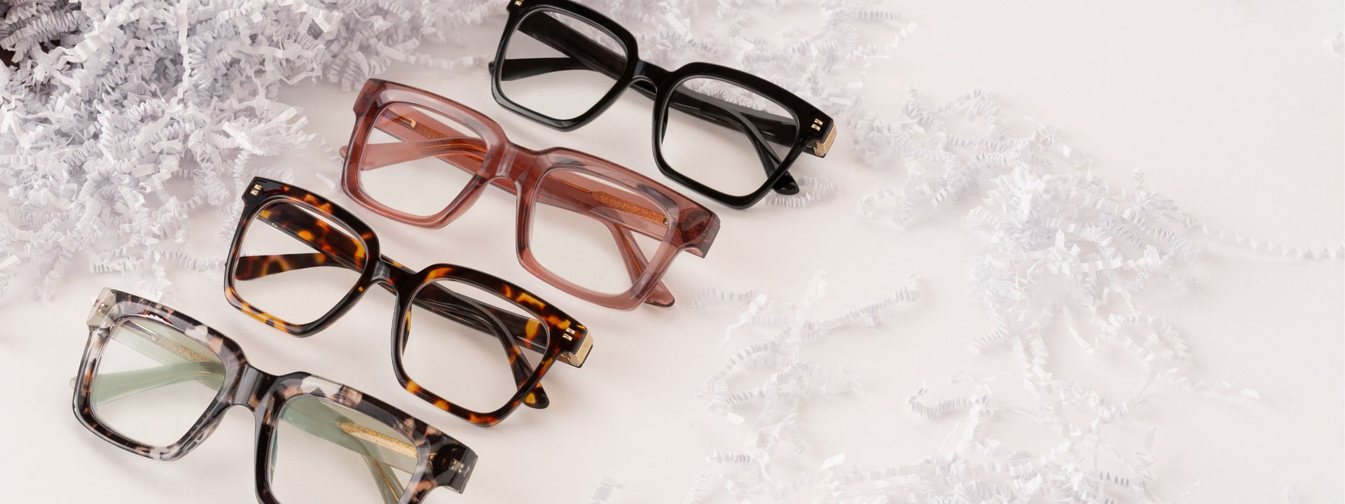 Main hero: four pairs of glasses, black, red, tortoise, and sand quartz/green