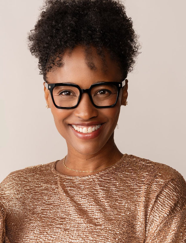 women wearing black Oprah's favorite things glasses and a gold shirt