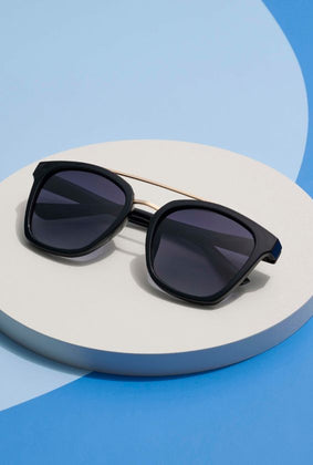 palm beach sunglasses with a blue background